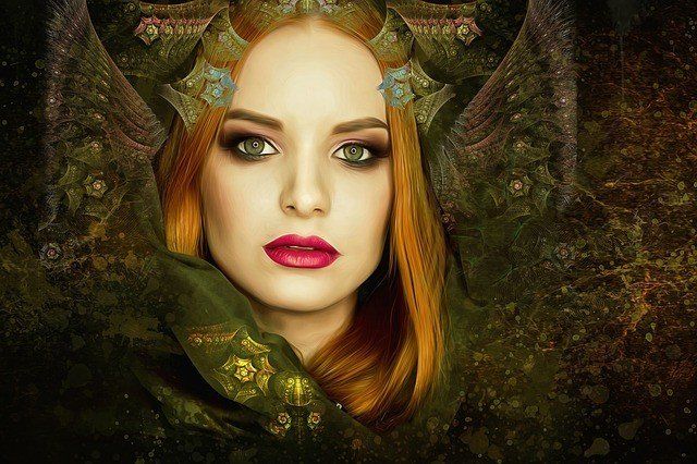 A person with reddish hair wears a green, ornate hooded garment against a dark, textured background.