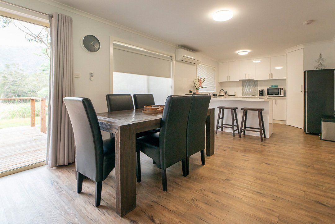 Spacious dining area adjoining luxury modern kitchen at Hideaway Villa, Halls Gap Valley Lodges.