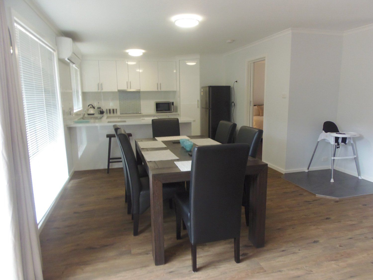 Spacious dining area adjoining luxury modern kitchen at Hideaway Villa, Halls Gap Valley Lodges.