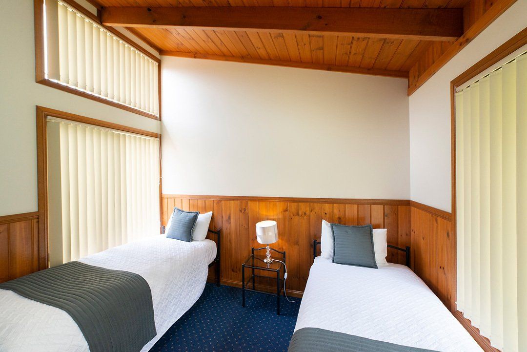 Spacious chalet-style lodges, bedroom with two single beds at Halls Gap Valley Lodges in The Grampians, Victoria.