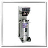 Stainless steel commercial coffee maker with a tall urn and a brewing mechanism.
