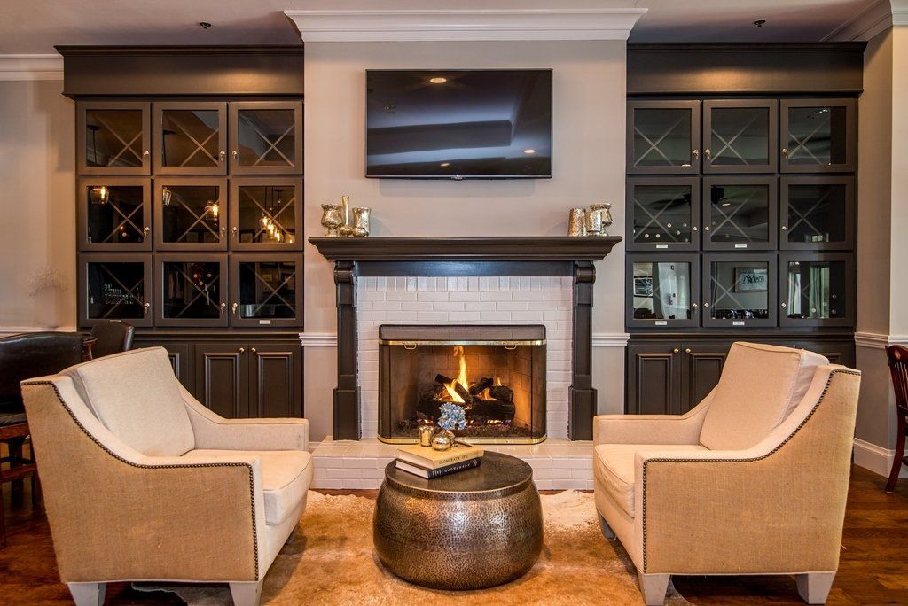 A living room with a fireplace and a flat screen tv