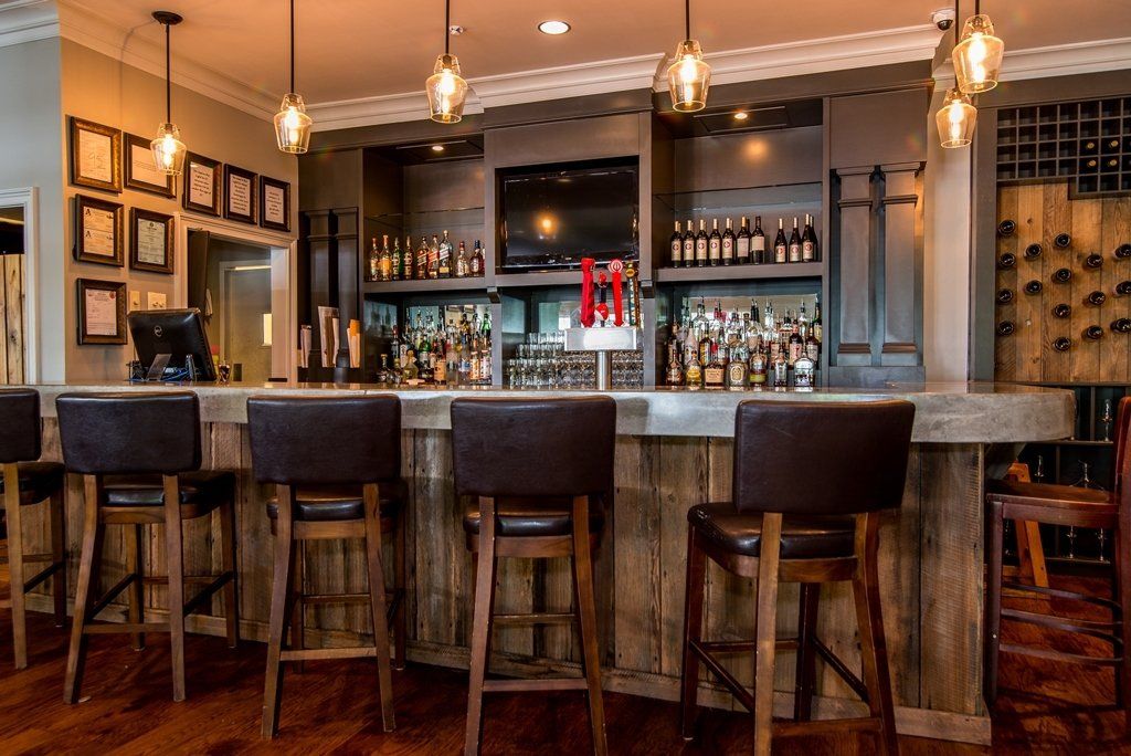 A bar with a lot of bottles of alcohol on it