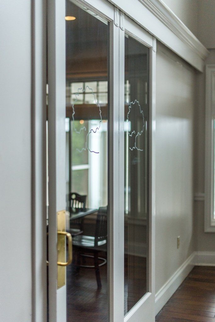 A door with a reflection of a chair in it