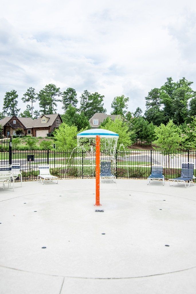 There is a water fountain in the middle of the pool.
