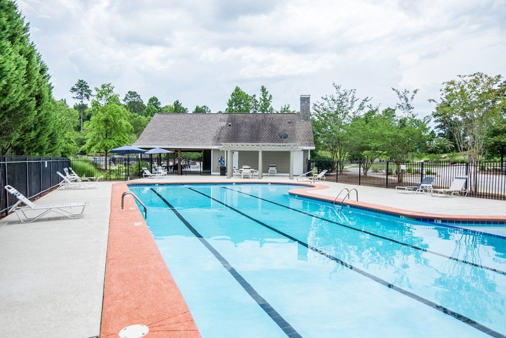 There is a large swimming pool with a gazebo in the background.