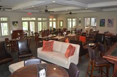 A large room with tables and chairs and a couch