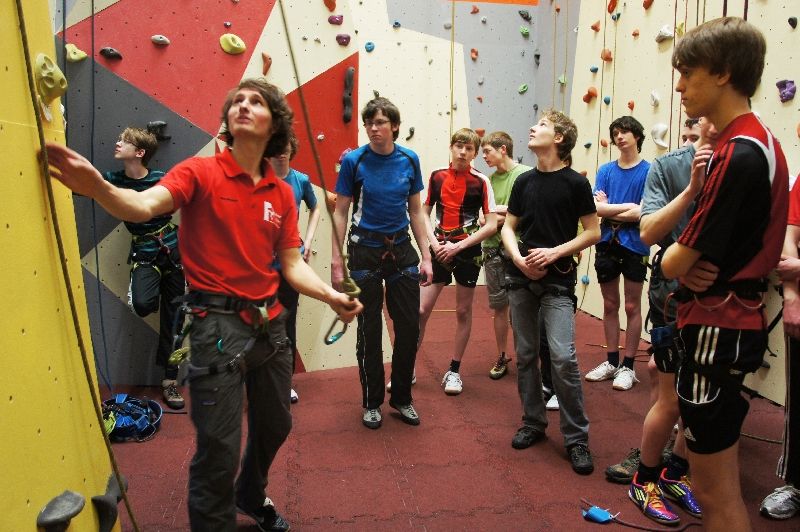 Eine Gruppe junger Männer steht vor einer Kletterwand