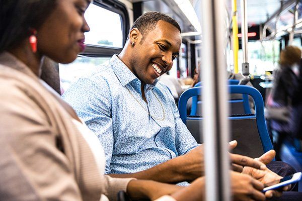 A couple smiling on a bus