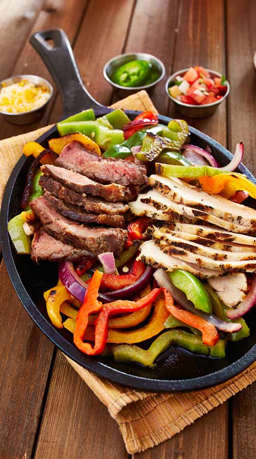 Chicken and Steak Mexican Fajitas — Mexican Cuisine in Sedalia, MO Chicken and Steak Mexican Fajitas — Mexican Cuisine in Sedalia, MO