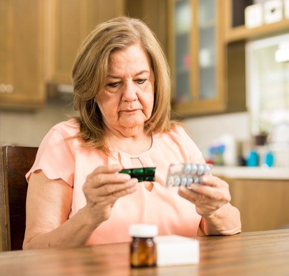 Elderly checking medicine expiration date - Return of Unwanted Medicine in Camden North Haven, NSW Elderly checking medicine expiration date - Return of Unwanted Medicine in Camden North Haven, NSW