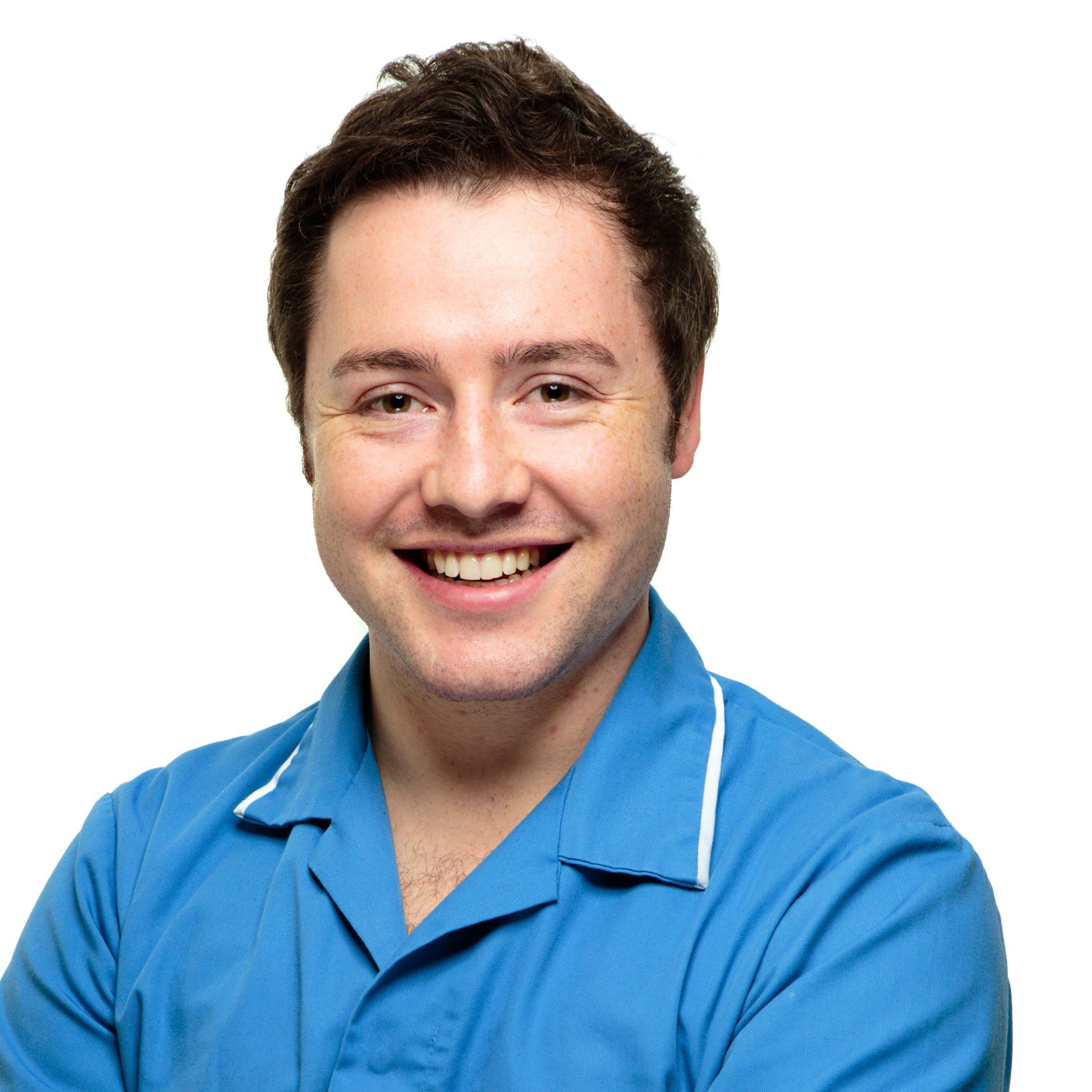 Professional headshot of a male nurse wearing bright blue uniform, stood on a white background