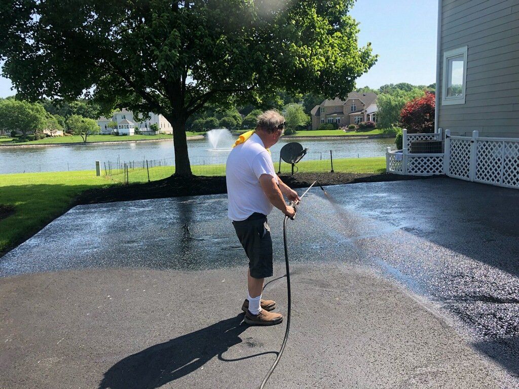 Applying Asphalt Sealcoat — Oilville, VA — Wells Paving & Seal Coating