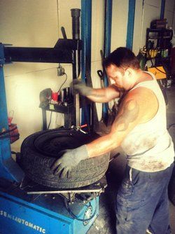 Working on tire - Towing and Garage in Garay, IN