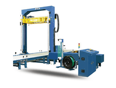 Máquina envolvedora de palets industrial azul con brazo amarillo y sistema de transporte sobre fondo blanco.