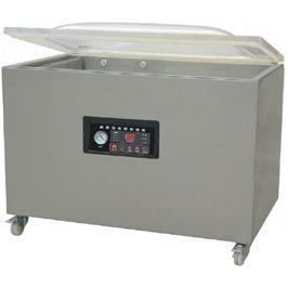 Selladora al vacío tipo arcón de acero inoxidable con tapa transparente y panel de control sobre ruedas.