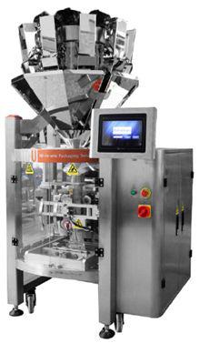 Máquina de envasado de acero inoxidable con panel de control táctil y tolva multicontenedor en la parte superior.