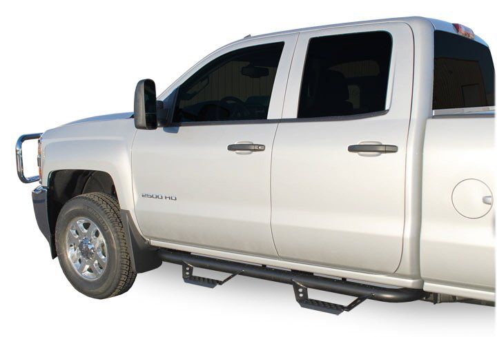 a white pickup truck with a custom nerf bar installed