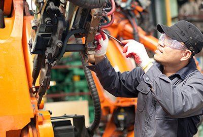 OEM Machine Builders — Mechanic Repairing a Machine in Granger, IN OEM Machine Builders — Mechanic Repairing a Machine in Granger, IN