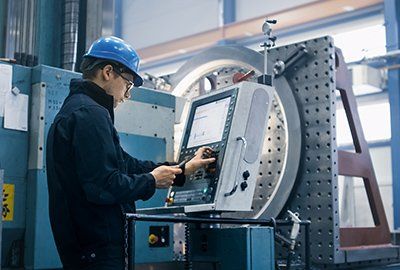 Machine Tool Retrofitting — Worker Programming a CNC Milling Machine with a Tablet Computer in Granger, IN