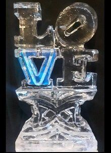 Snow filled single initial ice sculpture