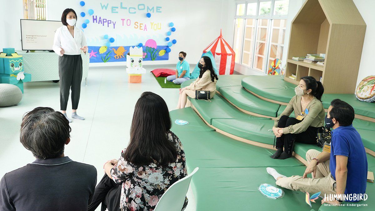 A group of people are sitting around a table in a room.