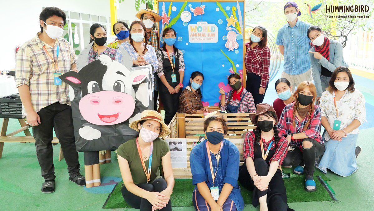 A group of people wearing face masks are posing for a picture.