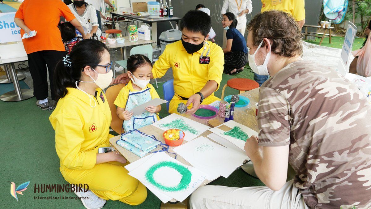 A group of people wearing face masks are sitting around a table.