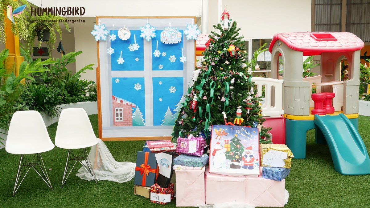 A christmas tree is sitting on top of a pile of presents.