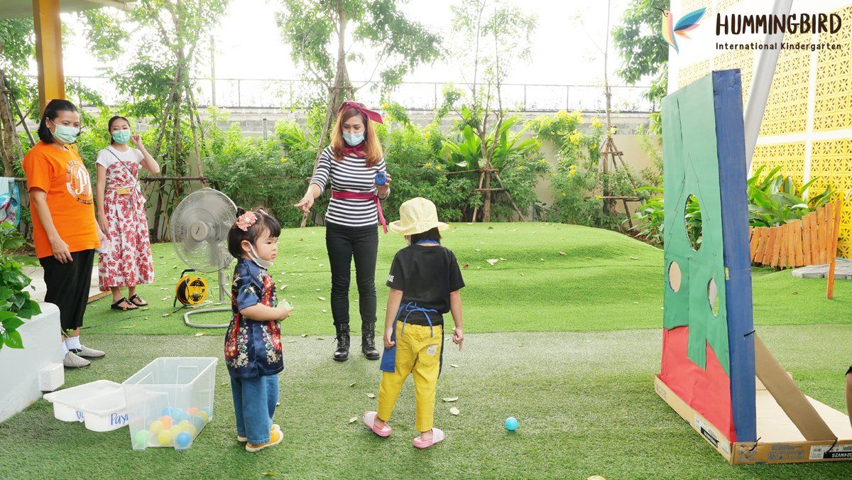 A group of children are playing a game in a park.