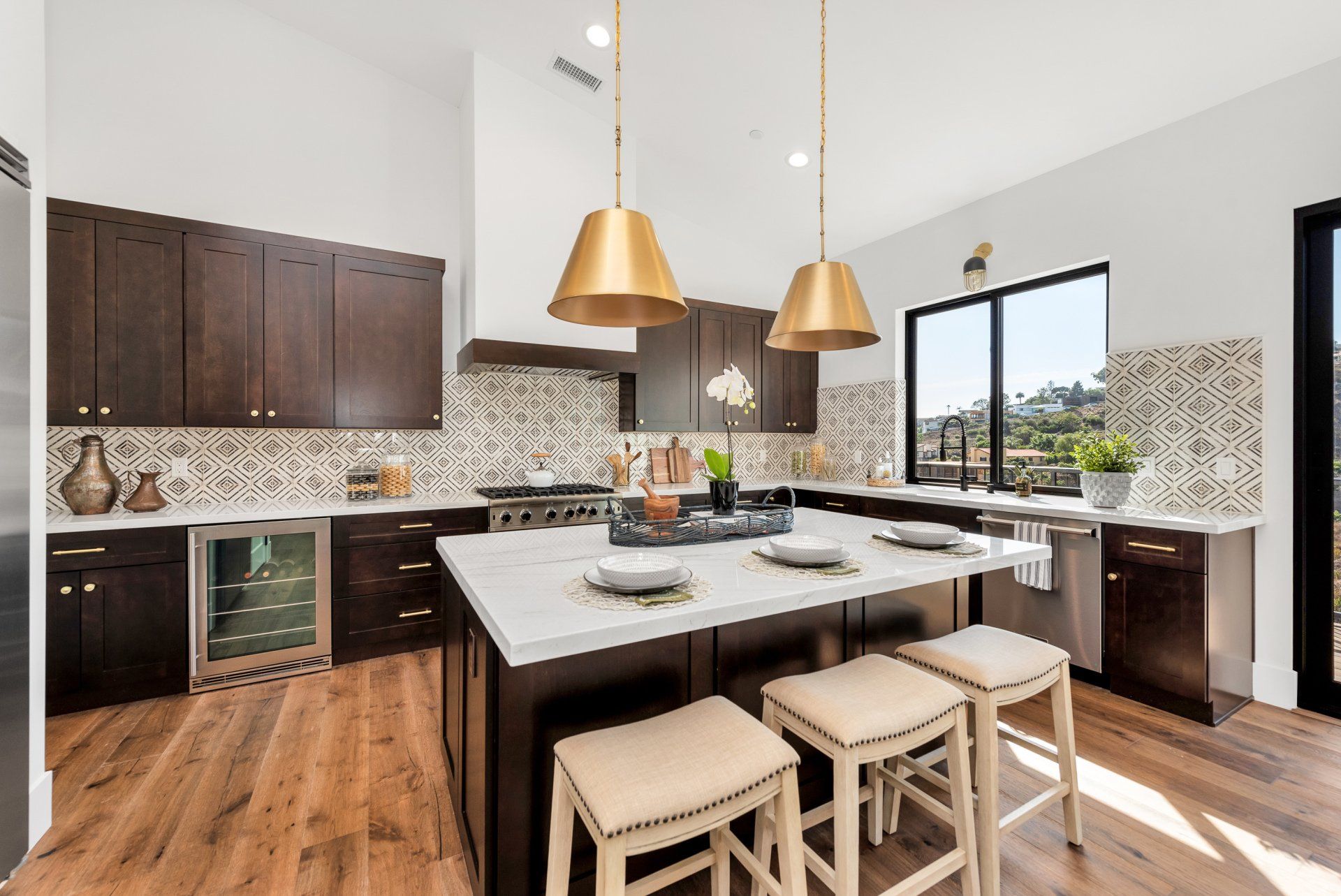 A kitchen with a large island and stools