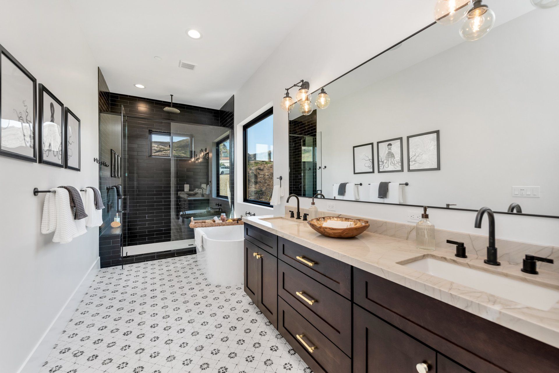 A long bathroom with two sinks, a tub, a shower, and a large mirror.