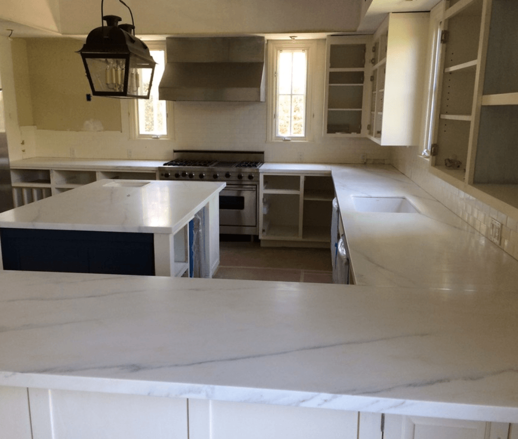 Kitchen renovation: white countertops, open cabinets, blue island, stainless steel range, lantern.
