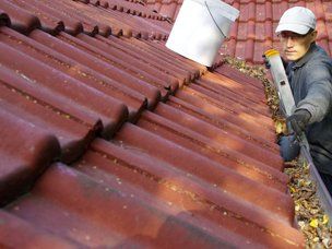 Gutter Cleaning — Man Removing Dirt In The Gutter In Mount Holly, NC