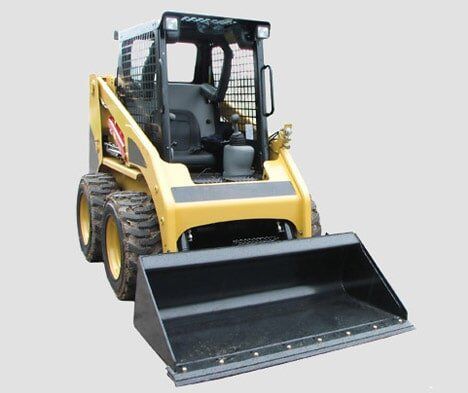 A yellow and black skid steer loader with a black bucket on a white background.