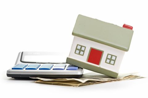 house on calculator on pile of money