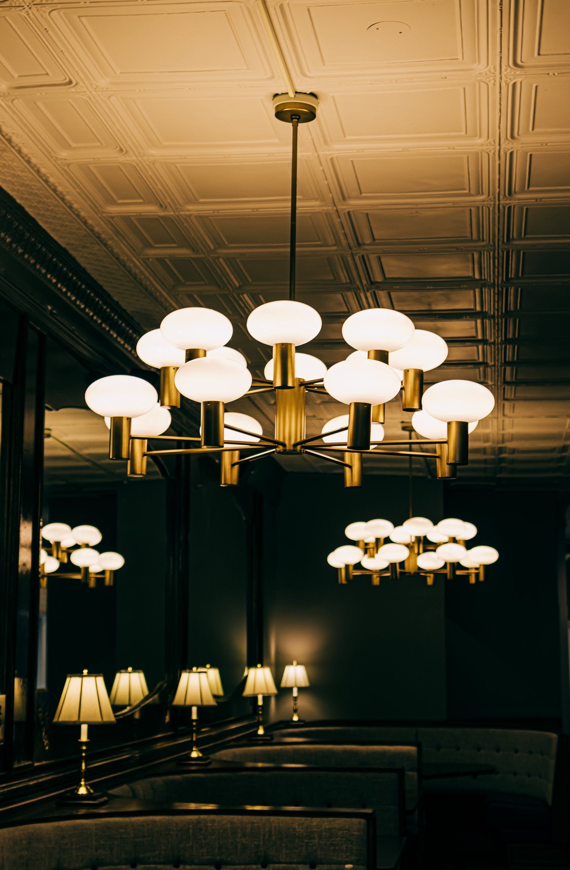 A restaurant with a chandelier hanging from the ceiling.