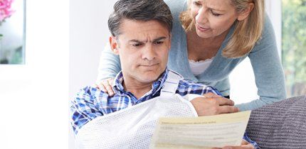 Personal injury injured man looking at hospital bill