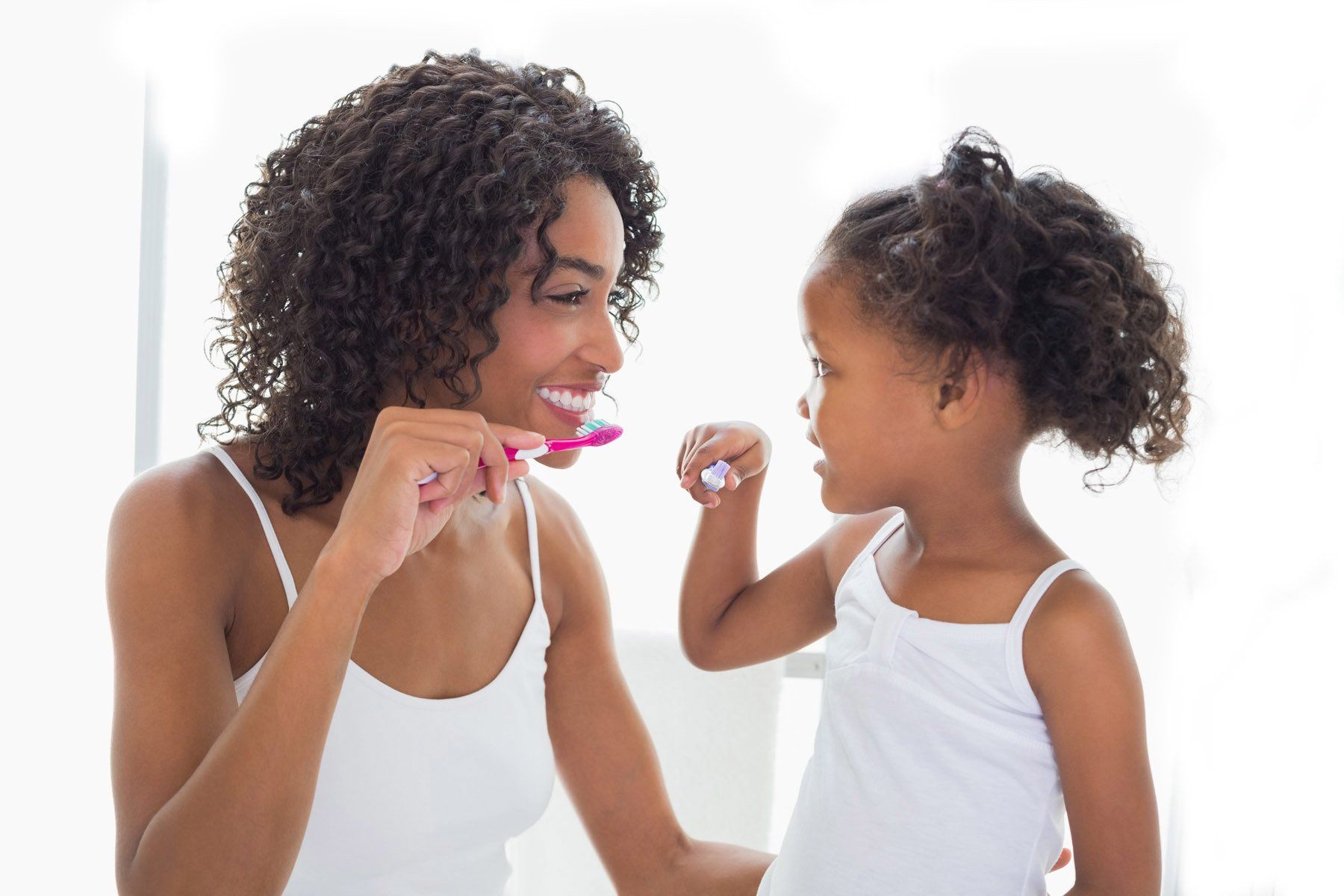 Mother and child brushing teeth