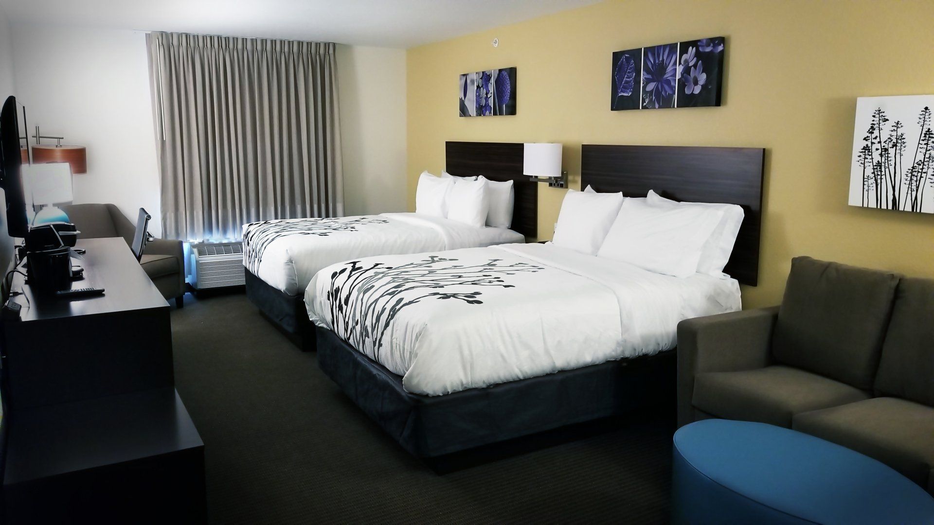 Photo of a hotel room with 2 queen beds and a couch