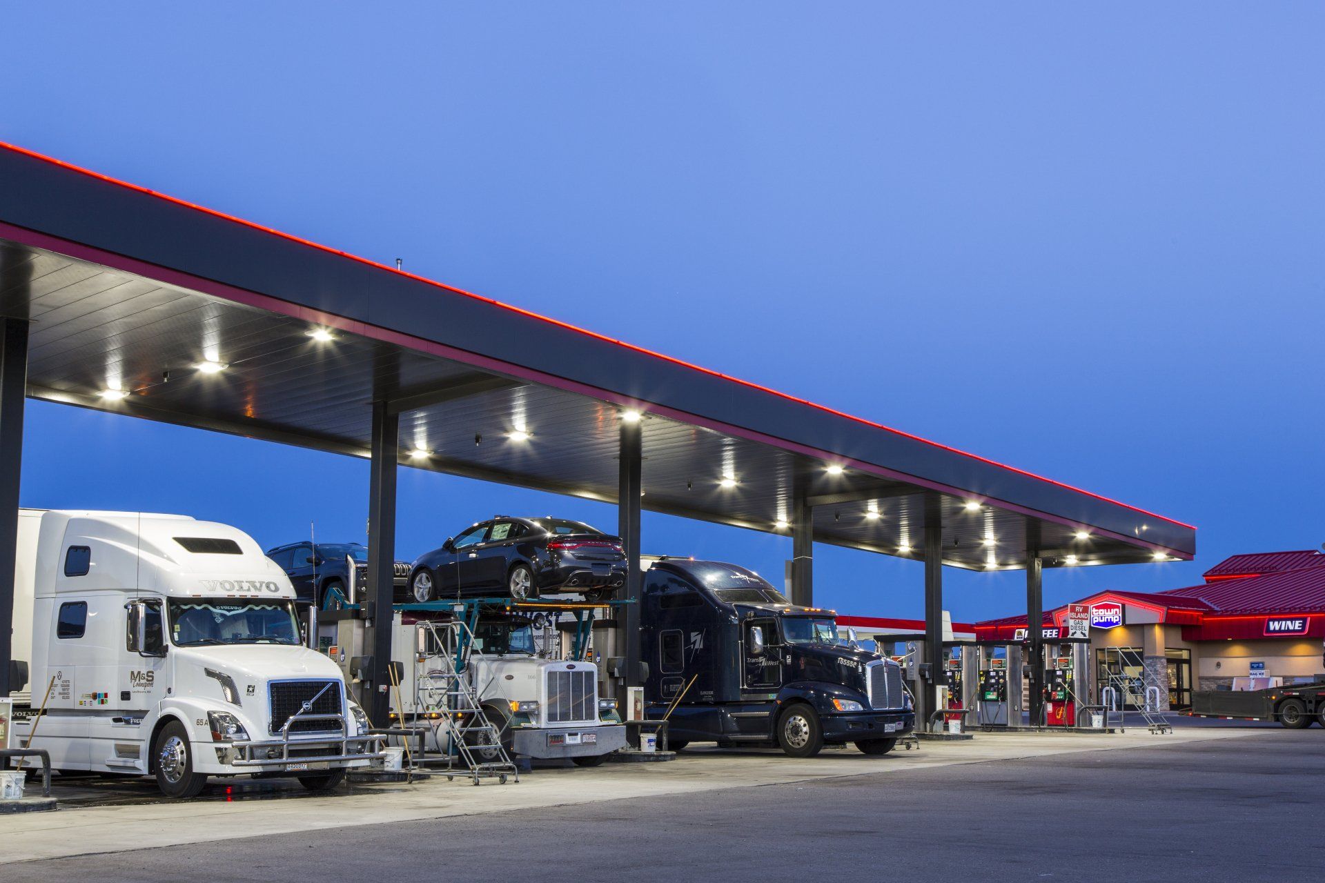 Photo of several semi trucks at a truck stop diesel island