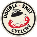 The logo for double shot cyclery has a cup of coffee on it.
