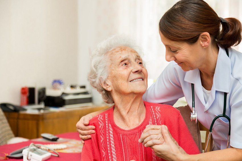 healthcare worker helping elder woman