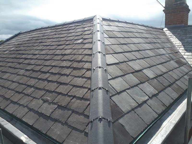 Slate roof tiles and ridge tiles on a roof