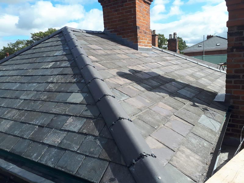 Chimney stack repair in the centre of a slate roof