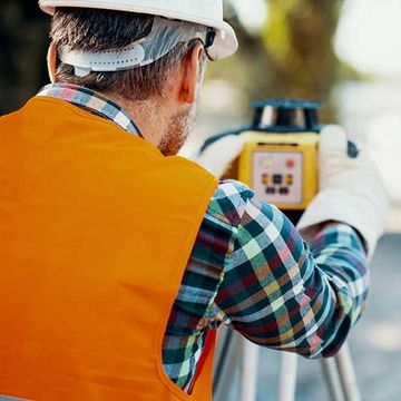 Geodesist In Orange Vest — Sharpsburg, GA — Turner & Associates Land Surveyors, P.C. Geodesist In Orange Vest — Sharpsburg, GA — Turner & Associates Land Surveyors, P.C.