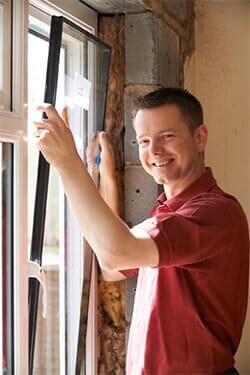 Man installing a new window — Glass Installation in Redondo Beach, CA Man installing a new window — Glass Installation in Redondo Beach, CA