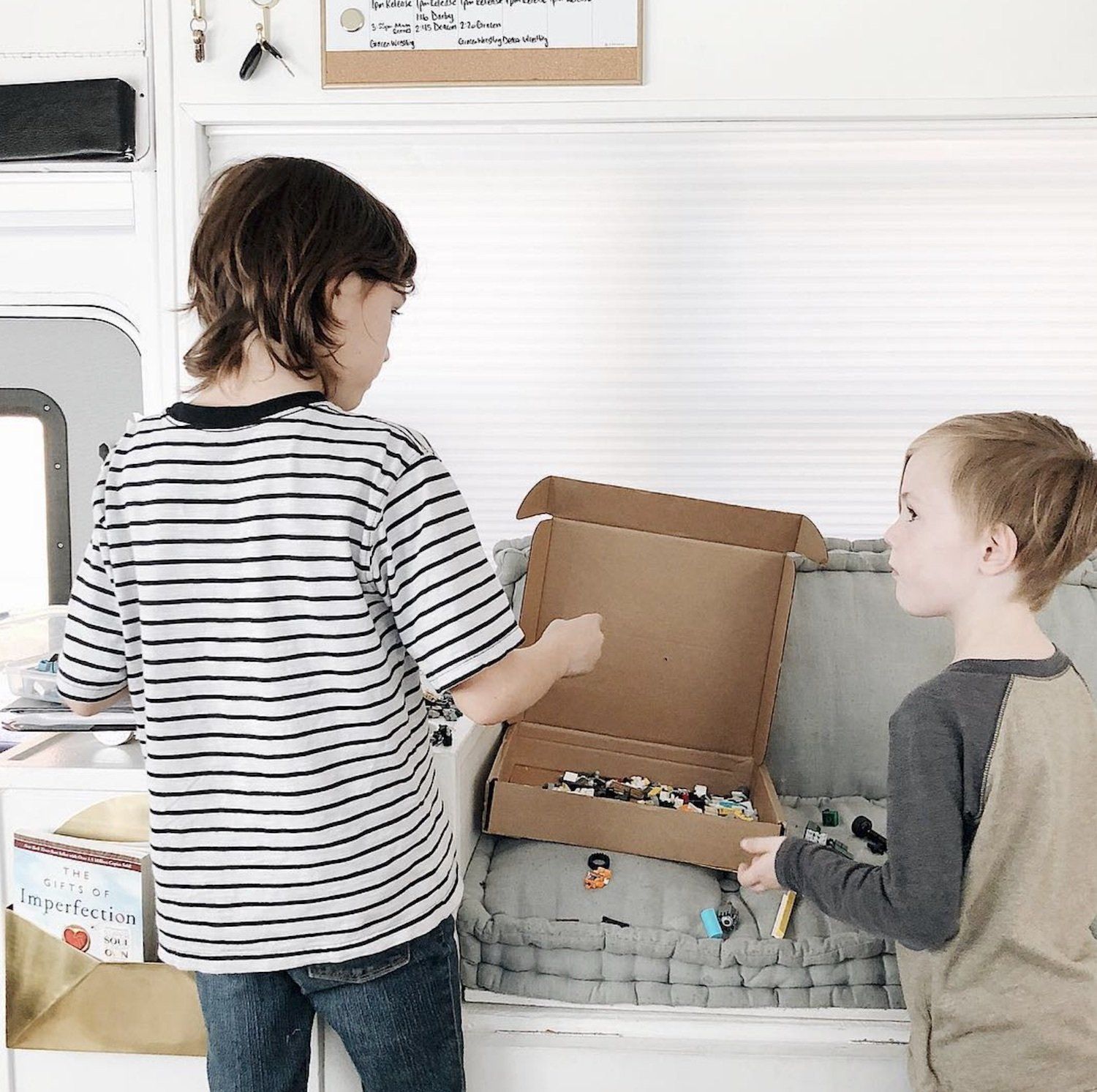 The Mayes Team children play with their toys, living on a bus full time.