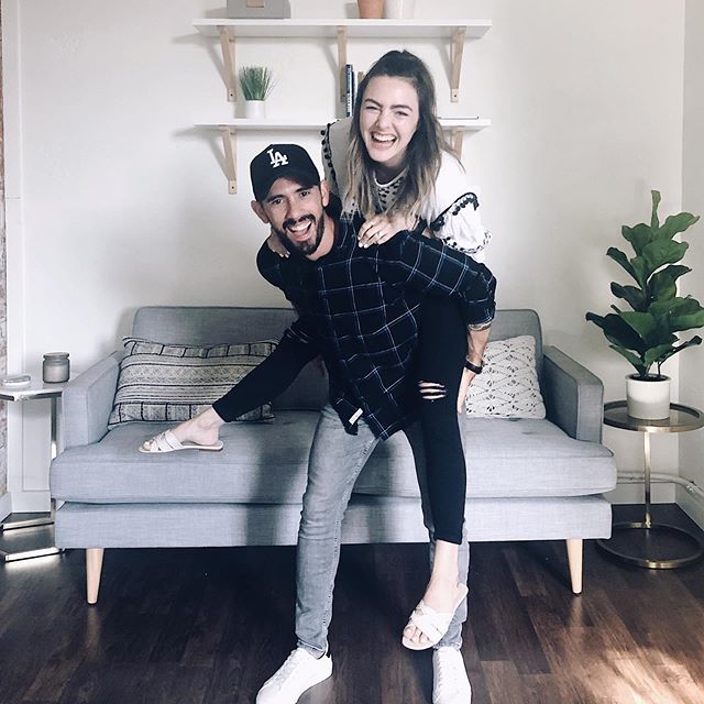 Debbie Mayes rides piggy-back on Gabriel Mayes as they look at the camera smiling