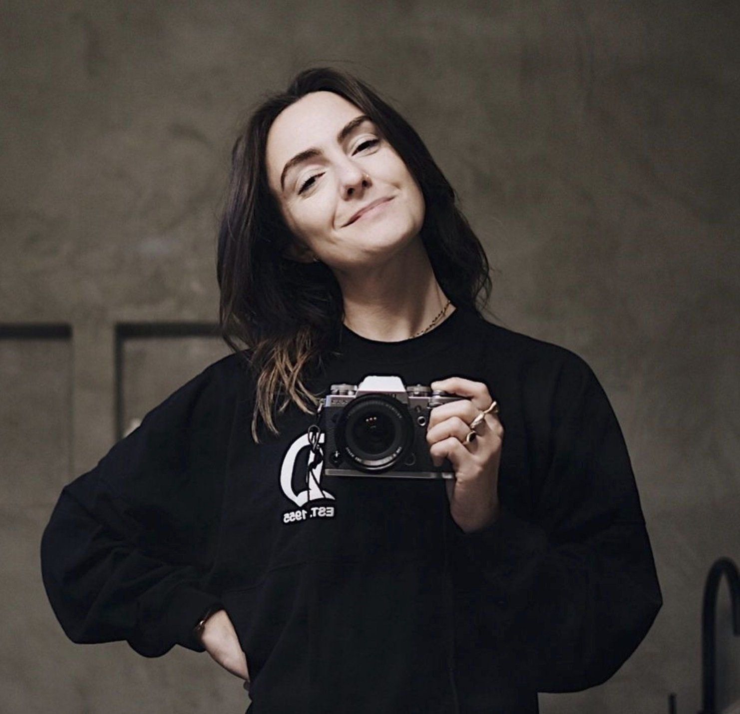 Debbie Mayes, who has an Instagram niche, takes a selfie with a film camera.